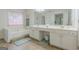 Bathroom featuring a large tub, tile floors, and dual sinks at 2022 Maple Ridge, Acworth, GA 30101