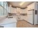 Bright kitchen featuring quartz countertops, white cabinetry, tile floors and stainless steel appliances at 2022 Maple Ridge, Acworth, GA 30101