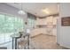 Modern kitchen with white cabinets, white appliances, lots of light, and a cozy breakfast nook at 2022 Maple Ridge, Acworth, GA 30101