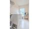 Bright laundry room with washer, dryer, and storage shelves at 2022 Maple Ridge, Acworth, GA 30101