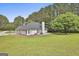 Aerial view showcasing a large backyard, patio, and mature trees surrounding the property at 391 Massengale Rd, Brooks, GA 30205