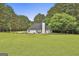 View of a large backyard and patio area featuring an open area and trimmed garden section around the back of the house at 391 Massengale Rd, Brooks, GA 30205