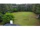 Expansive backyard featuring a lush green lawn and a secluded fire pit area, perfect for outdoor entertaining at 391 Massengale Rd, Brooks, GA 30205