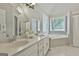 Well-lit bathroom with double vanity, a soaking tub, and a separate shower at 391 Massengale Rd, Brooks, GA 30205