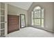 Bright bedroom featuring a large window, wooden dresser, and neutral walls at 391 Massengale Rd, Brooks, GA 30205