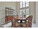 Elegant dining room with a round table, decorative furniture, and abundant natural light at 391 Massengale Rd, Brooks, GA 30205