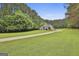 Beautiful home on lush green lawn; long driveway leads to trees and greenery at 391 Massengale Rd, Brooks, GA 30205