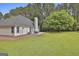 Lovely backyard with a well-maintained lawn, patio area, and mature trees providing ample shade at 391 Massengale Rd, Brooks, GA 30205