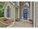 Welcoming front entrance with a vibrant blue door adorned with a floral wreath at 391 Massengale Rd, Brooks, GA 30205
