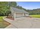 A well-maintained detached garage with an ample concrete parking area at 391 Massengale Rd, Brooks, GA 30205