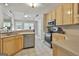 Bright kitchen featuring stainless steel appliances, light cabinetry, and an open view to the dining area at 391 Massengale Rd, Brooks, GA 30205