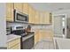 Well-equipped kitchen featuring stainless steel appliances, tile flooring, and bright cabinetry at 391 Massengale Rd, Brooks, GA 30205
