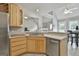 Cozy kitchen showcasing light wood cabinets, stainless steel appliances, and an open layout to living area at 391 Massengale Rd, Brooks, GA 30205
