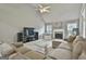 Spacious living room features a fireplace, ceiling fan, and lots of natural light at 391 Massengale Rd, Brooks, GA 30205