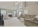 Open concept living room featuring a fireplace, fan and comfortable seating at 391 Massengale Rd, Brooks, GA 30205