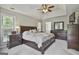 Spacious main bedroom with a tray ceiling, a large bed, and dark wood furniture at 391 Massengale Rd, Brooks, GA 30205