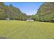 Large manicured front and side yard shows the home's location within a well landscaped parcel at 391 Massengale Rd, Brooks, GA 30205