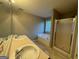 Bathroom featuring dual sinks, a large soaking tub, and a glass-enclosed shower at 851 Walkingstick Dr, Douglasville, GA 30134