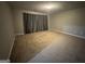 A neutral bedroom features carpeted flooring and window covered by full-length curtains at 851 Walkingstick Dr, Douglasville, GA 30134