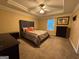 Spacious primary bedroom featuring carpet flooring, a ceiling fan, and a tray ceiling at 851 Walkingstick Dr, Douglasville, GA 30134