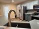 Modern kitchen featuring stainless steel appliances, gray cabinets, and quartz countertops at 851 Walkingstick Dr, Douglasville, GA 30134