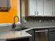 Bright kitchen with granite countertops, stainless steel appliances, and a sink overlooking an orange wall at 851 Walkingstick Dr, Douglasville, GA 30134