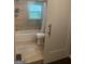 Bathroom featuring a toilet, a shower and a window at 288 Harper Se Rd, Atlanta, GA 30315