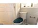 Bathroom with toilet, turquoise toilet seat cover, and door at 288 Harper Se Rd, Atlanta, GA 30315