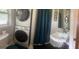 This bathroom features a stacked washer/dryer combo, toilet, vanity sink, and shower at 288 Harper Se Rd, Atlanta, GA 30315