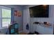 Bedroom with built-in shoe rack under television and storage unit at 288 Harper Se Rd, Atlanta, GA 30315