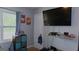 Bedroom with built-in shoe rack under television and storage unit at 288 Harper Se Rd, Atlanta, GA 30315