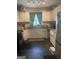 Updated kitchen featuring white cabinets, granite countertops, stainless steel appliances, and black tile floors at 288 Harper Se Rd, Atlanta, GA 30315