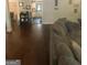 Open-concept living room with rich hardwood floors, leading to dining area and kitchen at 288 Harper Se Rd, Atlanta, GA 30315