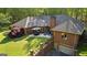 Aerial view of the house featuring a brick exterior, an outdoor patio and well-maintained lawn at 110 Woodland Rd, Fayetteville, GA 30214