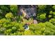 An aerial view of the estate featuring a beautiful home, pool, and lush green landscaping at 110 Woodland Rd, Fayetteville, GA 30214