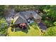 Aerial view of a well-kept property with a manicured lawn, patio, and a brick house at 110 Woodland Rd, Fayetteville, GA 30214