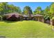 Spacious backyard with lush green grass and a beautiful brick patio, perfect for outdoor entertaining at 110 Woodland Rd, Fayetteville, GA 30214