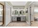 Bright bathroom featuring double vanity, round mirrors, and coordinated fixtures at 110 Woodland Rd, Fayetteville, GA 30214