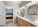 Bathroom features a double sink vanity with marble countertop and an adjoining bedroom at 110 Woodland Rd, Fayetteville, GA 30214