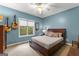 Comfortable bedroom with blue walls, guitars, ceiling fan, and natural light at 110 Woodland Rd, Fayetteville, GA 30214