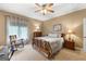 Relaxing bedroom with a comfortable bed, rocking chair, and natural light streaming through the window at 110 Woodland Rd, Fayetteville, GA 30214