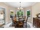 Well-lit dining space features a wooden table with seating and outdoor scenery at 110 Woodland Rd, Fayetteville, GA 30214