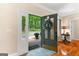Inviting entryway featuring an open door, hardwood floors, and a glimpse of the scenic outdoors at 110 Woodland Rd, Fayetteville, GA 30214