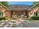 Inviting entrance with double doors, beautiful brickwork, and cozy seating on the porch at 110 Woodland Rd, Fayetteville, GA 30214