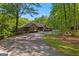 Beautiful brick home with mature landscaping, long driveway, and a serene, wooded backdrop at 110 Woodland Rd, Fayetteville, GA 30214