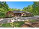 Stunning brick home with a lush, tree-lined landscape and private driveway at 110 Woodland Rd, Fayetteville, GA 30214