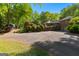 Long driveway and a partial view of the house and backyard with patio at 110 Woodland Rd, Fayetteville, GA 30214