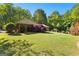 Beautiful home exterior with a lush green lawn and vibrant Japanese Maple trees enhancing the curb appeal at 110 Woodland Rd, Fayetteville, GA 30214
