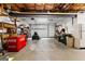 Spacious garage with a Coca-Cola refrigerator, tool bench, and lawn mower at 110 Woodland Rd, Fayetteville, GA 30214
