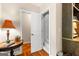 Hallway with hardwood floors and access to additional room with stairs and a built-in bookshelf at 110 Woodland Rd, Fayetteville, GA 30214